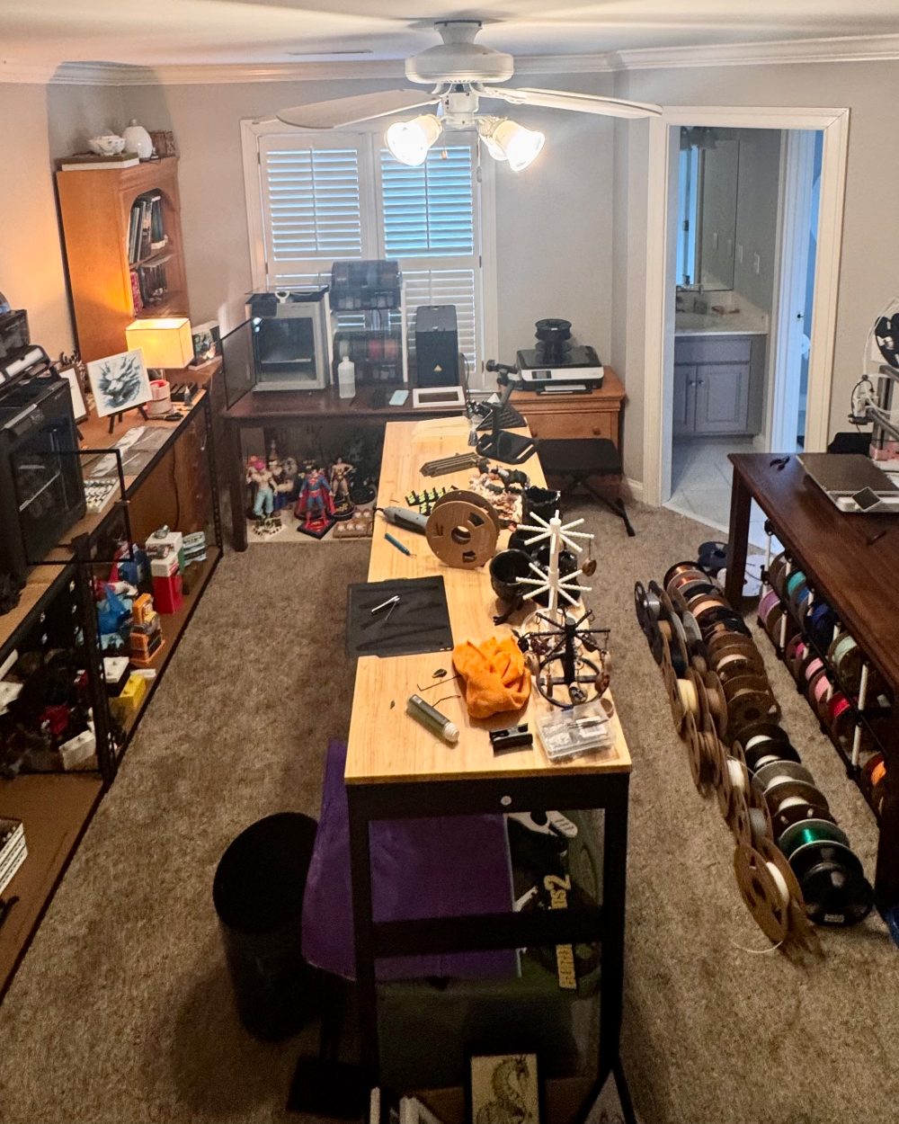 Will Bennett's 3D-printing workshop — print bench, filament shelves, and printers